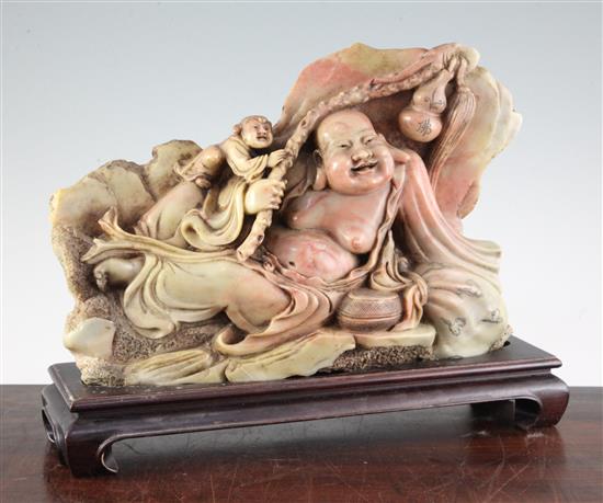 A large Chinese soapstone group of a recumbent Budai and an attendant, mid 20th century, total length 38.5cm